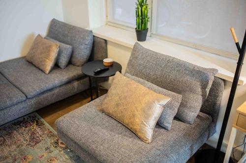 a living room with two couches and a table at Stylish 50m2 Two-Bedroom Apartment - SD23K in Eindhoven