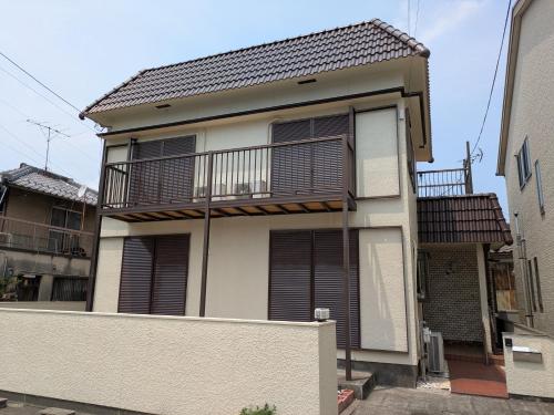 an apartment building with a balcony and a fence at Villa Ishiba-Otsu by Kyoto ヴィラ石場大津 by 京都 in Otsu