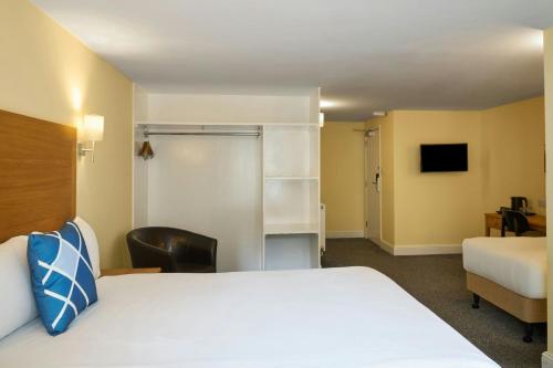 a hotel room with a bed and a chair at Four Points Flex by Sheraton Brighton in Brighton & Hove