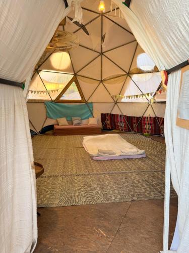 a room with a tent with a mattress in it at חוות רפאל in Mashabbe Sade