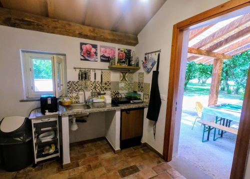 a kitchen with a sink and a counter top at Podere Vasella Suite junior dx in Capranica