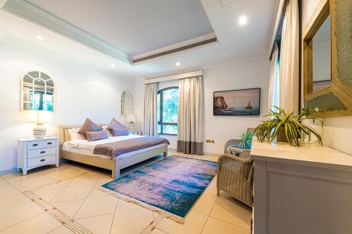 a bedroom with a king sized bed and a rug at Palm Jumeirah Beachfront private pool villa 5 BR & 1 maids room with access to beach in Dubai