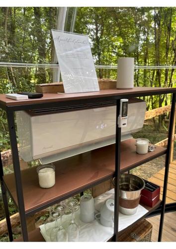 a shelf with cups and wine glasses on it at La bulle 