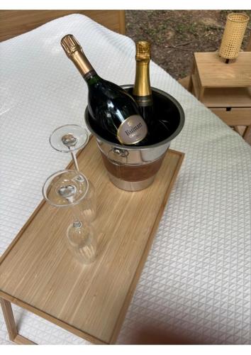 a bottle of champagne and a wine glass on a table at La bulle 