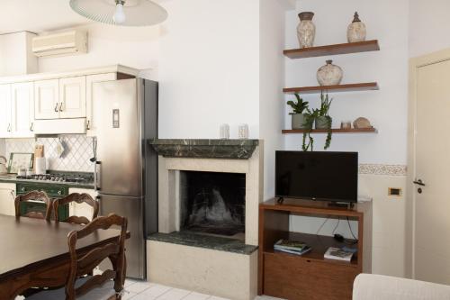 a kitchen with a living room with a fireplace at Chicca Casa Vacanze in Casarano