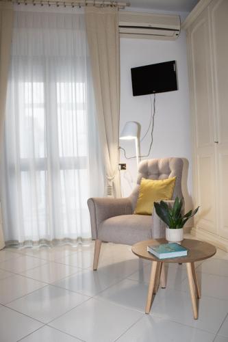 a living room with a chair and a table at Chicca Casa Vacanze in Casarano
