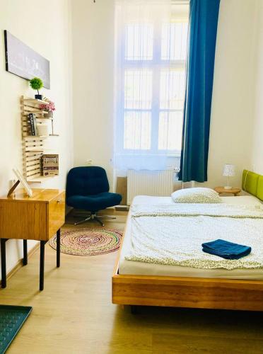 a bedroom with a bed and a desk and a chair at Hostel Moravia Ostrava in Ostrava