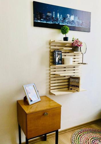 a room with a table and a shelf on a wall at Hostel Moravia Ostrava in Ostrava