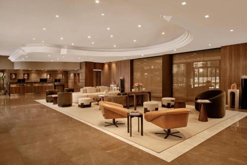 a lobby with chairs and tables in a building at AC Hotel by Marriott Nice in Nice