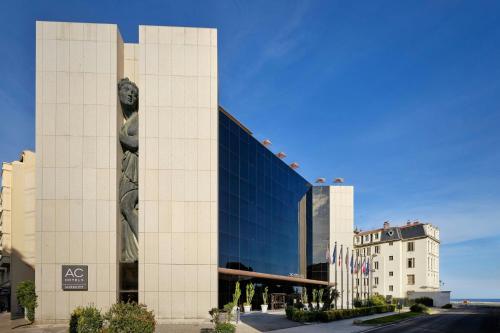 a large building with a statue in front of it at AC Hotel by Marriott Nice in Nice