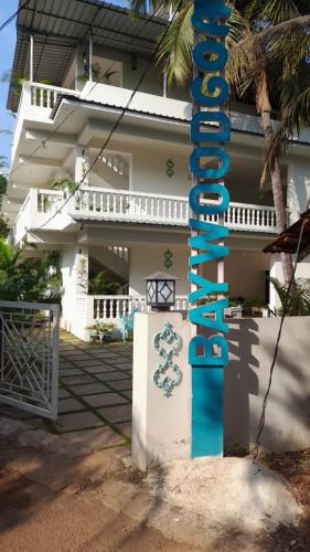 a pole in front of a house with a sign at BaywoodGoa -200 meters from Morjim Beach in Morjim
