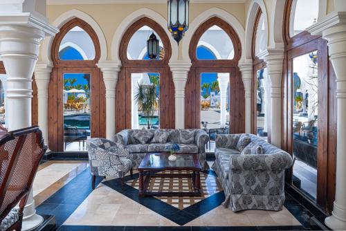 a living room with two couches and a table at Grand Makadi - Couples and Families Only in Hurghada