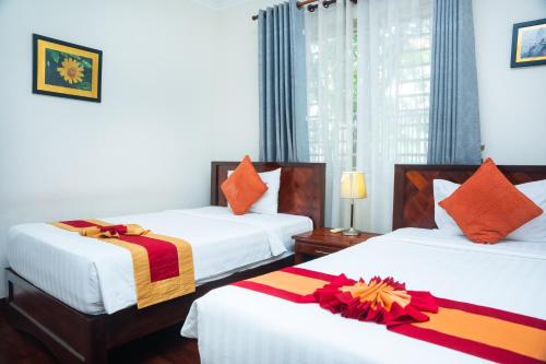 Postel nebo postele na pokoji v ubytování Siemreap Green Residence