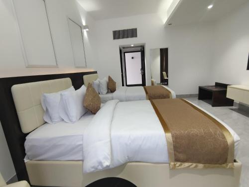 a bedroom with two beds in a room at Royal Mark Hotel in Sylhet