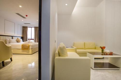 a living room with a couch and a bedroom at Royal Mark Hotel in Sylhet
