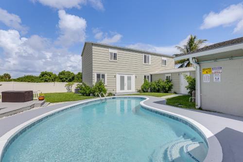 a swimming pool in front of a house at 5 Mi to Boat Cruises! WPB Retreat with Pool Access in West Palm Beach