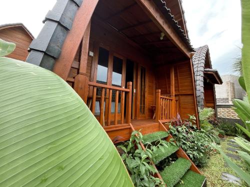 a house with a large green object in front of it at De Ravin Bungalows Canggu in Dalung
