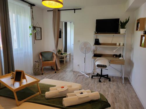a living room with a couch and a desk at Le Guèlèf - Appartement 2 personnes in Orbey