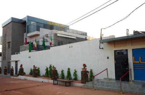 a building with a bunch of plants in front of it at Luxury Palace 