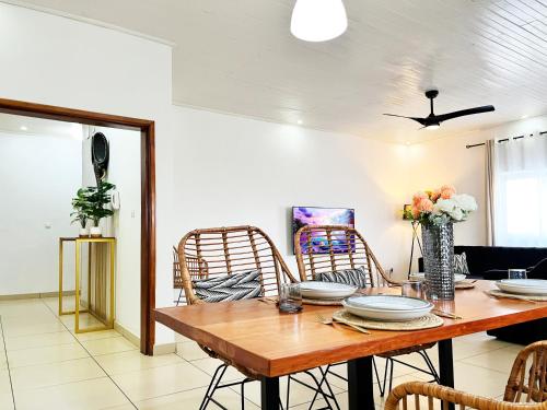 a dining room with a wooden table and chairs at Residence Atlantic - Premium Apartment - WiFi, Gardien, Parking, Climaté in Douala