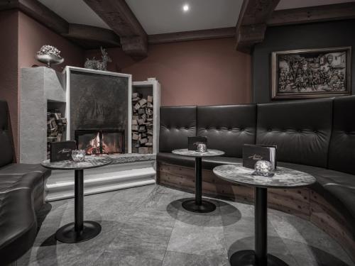 a restaurant with two tables and a fireplace at Apartment Alpenland in Obergurgl