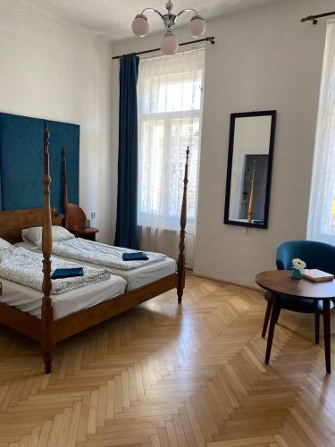 a bedroom with a bed and a table and a mirror at Hostel Moravia Ostrava in Ostrava
