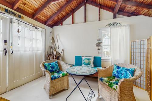 a living room with a table and chairs at Mermaid Cottage in Falmouth