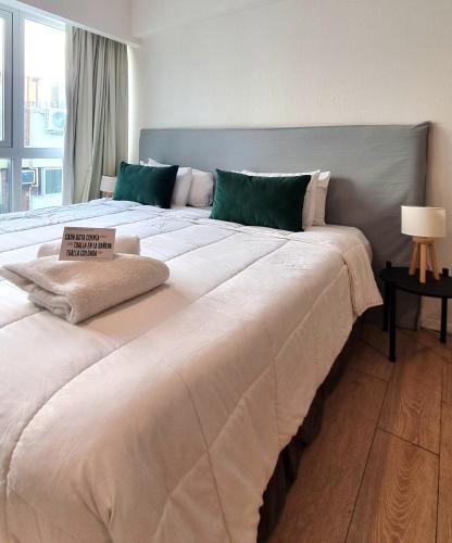 a large bed with a sign on top of it at Top Rentals Belgrano in Buenos Aires