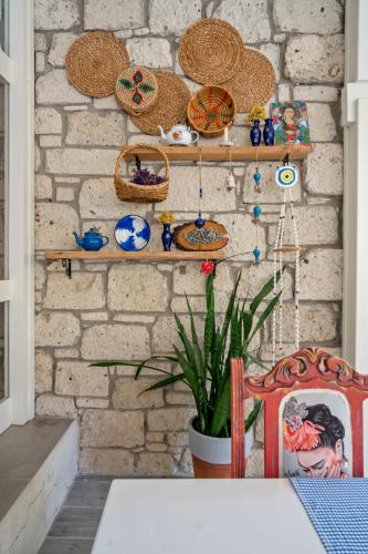 a room with a brick wall with shelves and a table at Bademli Konak Otel in Datca
