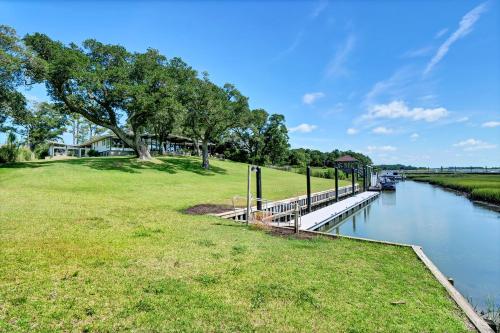 a park next to a river with a bridge at Masons View by Sea Scape Properties in Wrightsville Beach