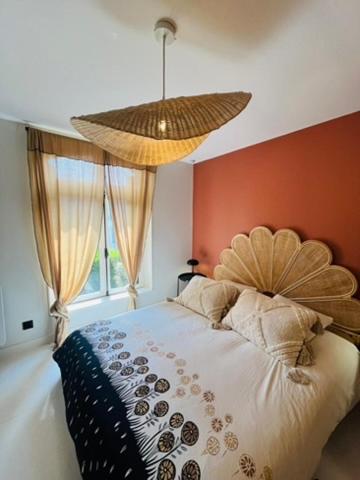 a bedroom with a bed and a large window at Le petit Cosy in Le Touquet-Paris-Plage