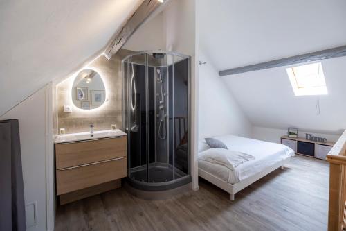 ein Badezimmer mit Dusche und Waschbecken und ein Bett in der Unterkunft T2 Contemporain idéalement situé in Briançon