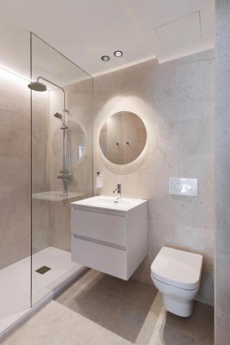 a bathroom with a white sink and a toilet at Ca Gracia Bocairent in Bocairent