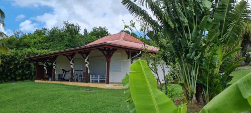 a house with a gazebo in a yard at Chambre d'hotes "Villa Rayon Vert" in Deshaies