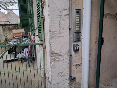 an external door to a house with a balcony at Autun cœur de ville in Autun