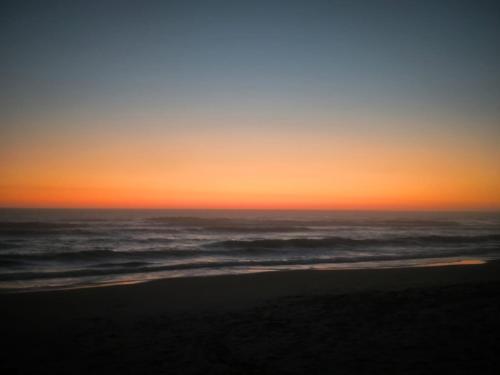 a sunset on a beach with the ocean at Détente et calme proche bassin in Mios