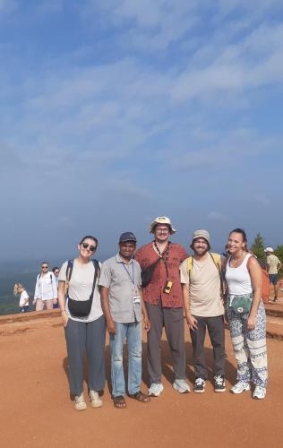a group of people posing for a picture at Green Bamboo House in Sigiriya