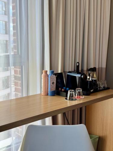 a counter top with items on it next to a window at ibis London Canning Town in London