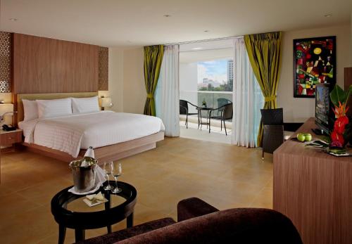a bedroom with a bed and a living room at Centara Pattaya Hotel in Pattaya