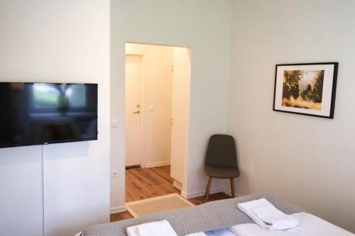 a bedroom with a bed and a television on a wall at Hotell Åre Fjällsätra in Undersåker