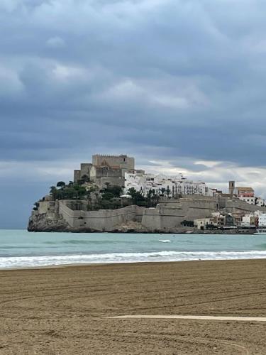a view of a beach with a castle in the background at EL LLIMONER in Sant Jordi