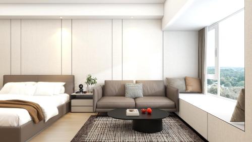 a bedroom with a bed and a couch and a table at Yizhi Hotel Guangzhou Zhujiang New Town US Consulate General Guangzhou Branch - Free Shuttle Bus to Canton Fair Complex During Canton Fair Period in Guangzhou