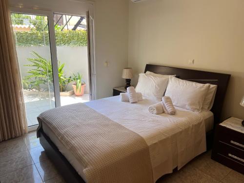 a bedroom with a large bed with towels on it at Cozy Kolonaki Retreat in Kremasti