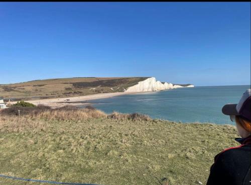 a person standing on a cliff looking at the ocean at Western style living in Telscombe