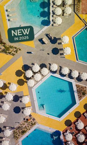 an overhead view of a swimming pool with umbrellas at Aminess Style Glamping Villas & Holiday Homes Atea in Njivice