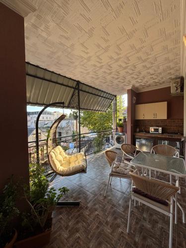 a living room with a balcony with a table and chairs at Sunny Days in K'obulet'i
