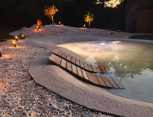 a pool of water with a wooden boat in it at as Alvarizas in Moraña