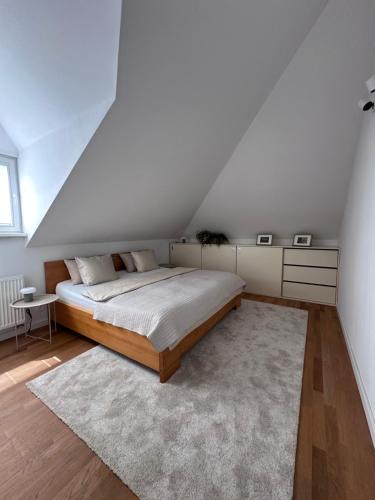 a bedroom with a bed and a white ceiling at Bratislava Danube&Castle Retreat Apartment, 70m2 in Bratislava