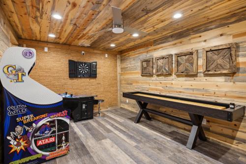a log cabin with a ping pong table and a piano at Experience luxury at Smoky Mountain Hideaway, just 5 miles from downtown Gatlinburg in Gatlinburg