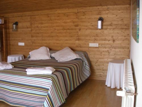 a bedroom with a large bed with two tables at Casa del Renacimiento in Alcaraz